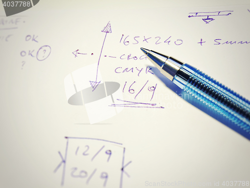 Image of Pen with notes written on paper