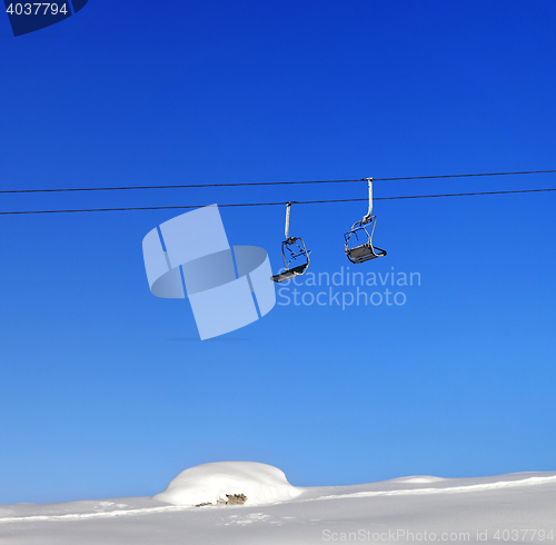 Image of Chair-lift and blue clear sky at sunny day