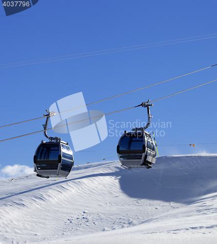 Image of Gondola lift on ski resort at windy sun day