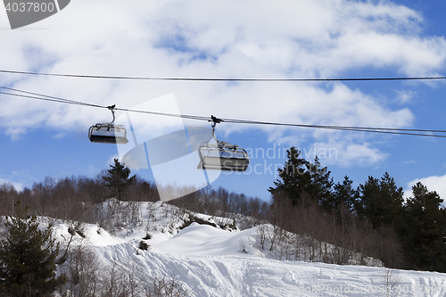 Image of Chair-lift and off-piste slope in ski resort