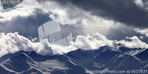 Image of Panoramic view on evening mountains in clouds