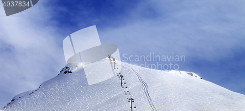 Image of Panoramic view on ski slope and chair-lift.