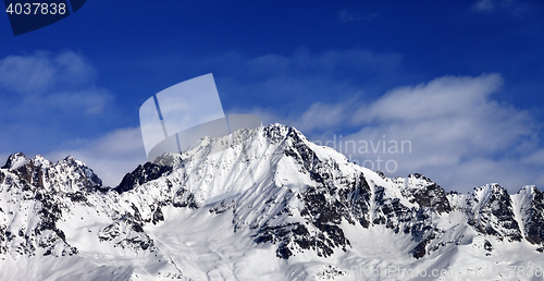 Image of Panoramic view on snowy mountains at sun day