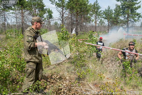 Image of Athletes run on a ravine in extrim race. Tyumen