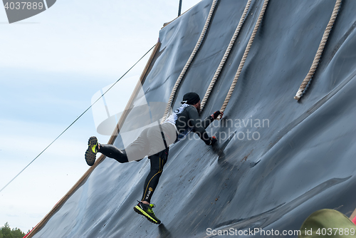 Image of Sportsman storms big wall in extrim race. Tyumen