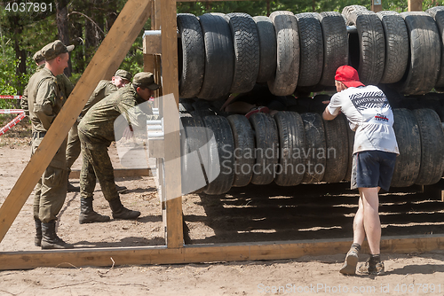 Image of Sportsmen move between old tires. Tyumen