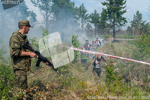 Image of Athletes run on a ravine in extrim race. Tyumen