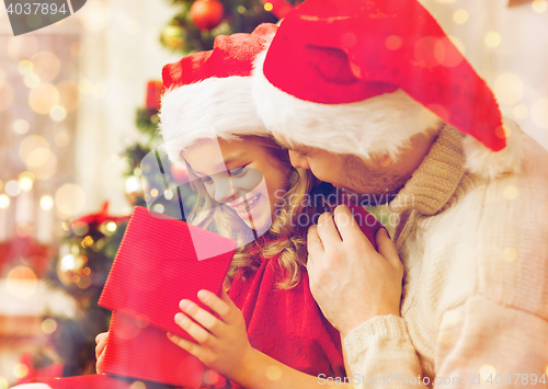 Image of smiling father and daughter opening gift box