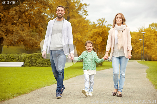 Image of happy family walking in autumn park