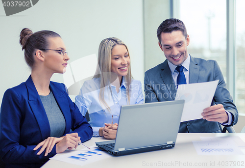 Image of business team with laptop having discussion