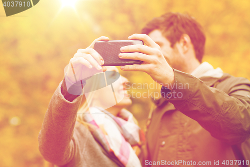 Image of couple taking selfie with smartphone in park