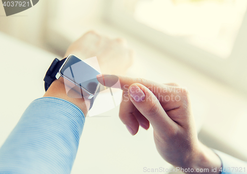 Image of close up of hands setting smart watch