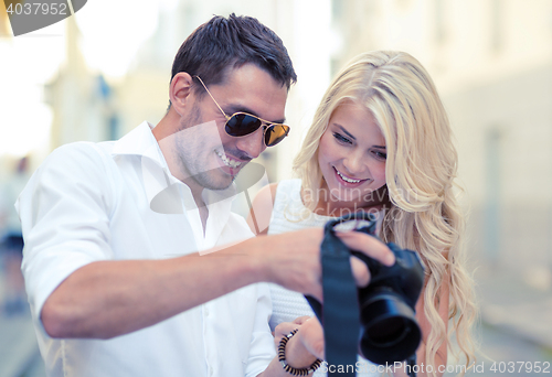 Image of smiling couple with photo camera