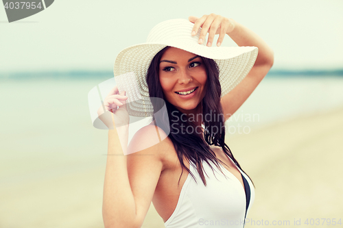 Image of happy young woman on beach