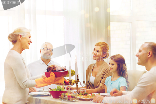 Image of smiling family having holiday dinner at home