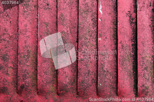 Image of close up of old red rusty metal flaps