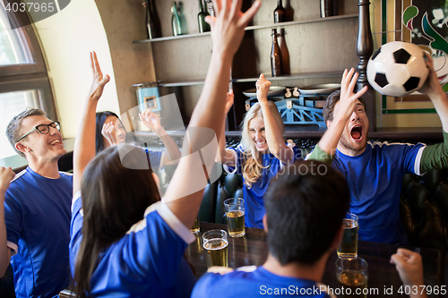 Image of football fans or friends with beer at sport bar