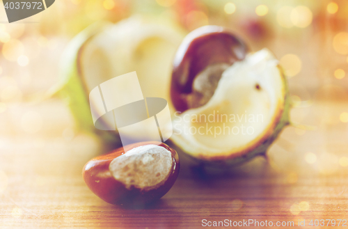 Image of close up of chestnut on wooden table