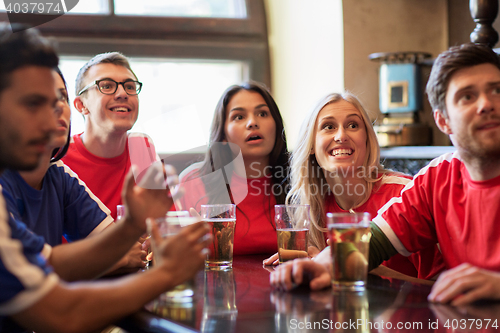 Image of fans or friends watching football at sport bar