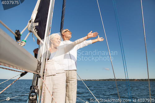 Image of senior couple hugging on sail boat or yacht in sea