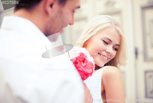 Image of couple with flowers in the city