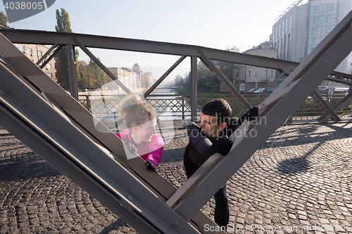 Image of couple warming up before jogging