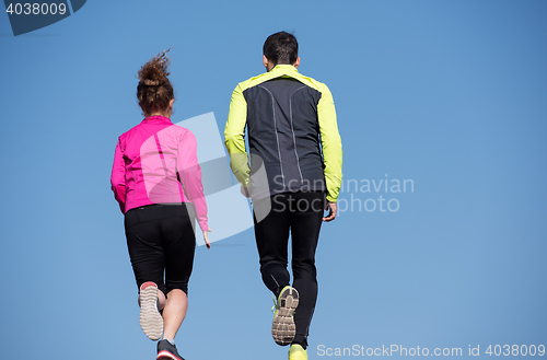 Image of young  couple jogging on steps