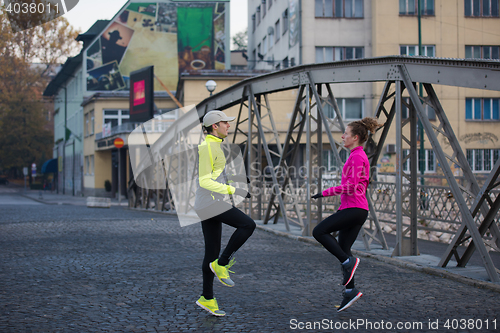 Image of couple warming up before jogging