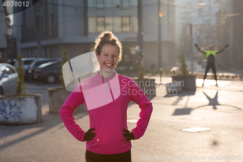 Image of woman  stretching before morning jogging