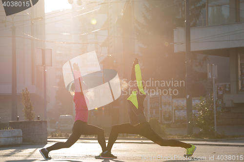 Image of couple warming up before jogging