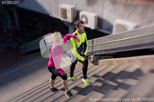 Image of young  couple jogging on steps