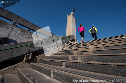 Image of young  couple jogging on steps