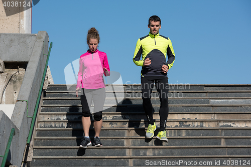 Image of young  couple jogging on steps