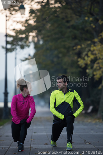 Image of couple warming up before jogging