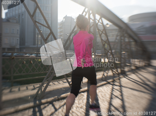 Image of sporty woman jogging on morning