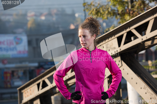 Image of woman  stretching before morning jogging