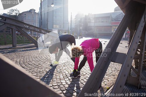 Image of couple warming up before jogging