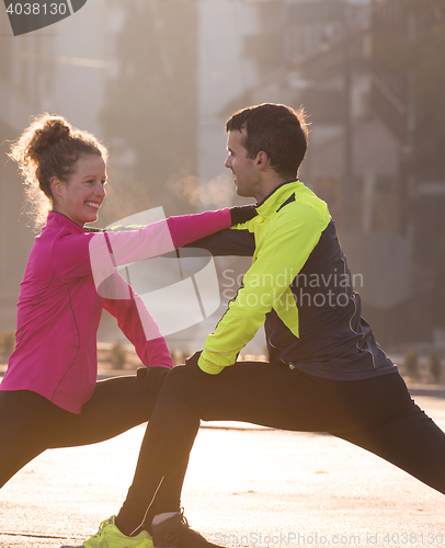 Image of couple warming up before jogging