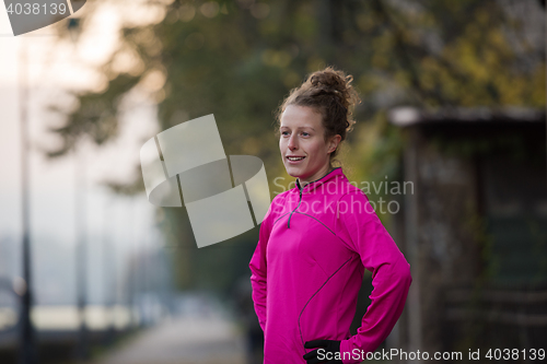 Image of woman  stretching before morning jogging