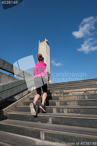 Image of young  couple jogging on steps