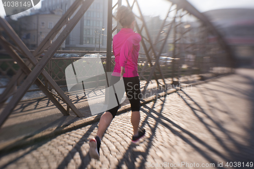 Image of sporty woman jogging on morning