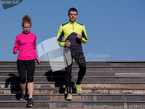 Image of young  couple jogging on steps