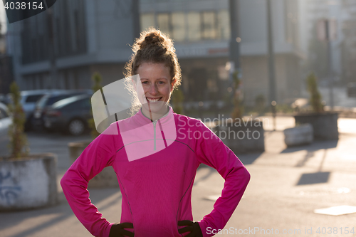 Image of woman  stretching before morning jogging