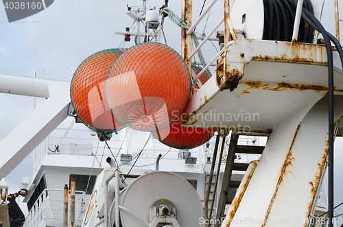 Image of three big float on big fishingboat 