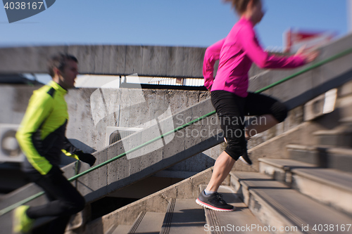 Image of young  couple jogging on steps