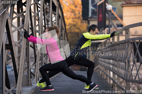 Image of couple warming up before jogging