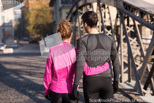 Image of couple warming up before jogging