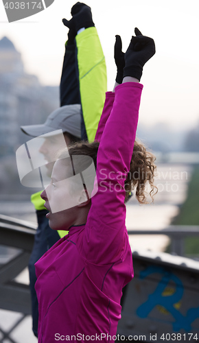 Image of couple warming up before jogging