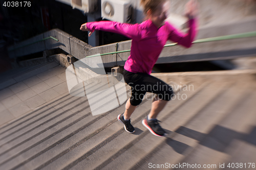 Image of woman jogging on  steps