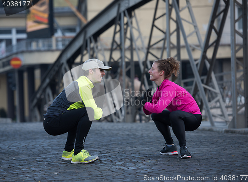 Image of couple warming up before jogging